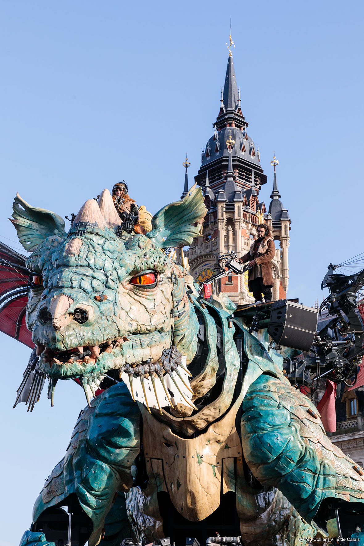 A large mechanical and colourful dragon, in front of Calais Town Hall.